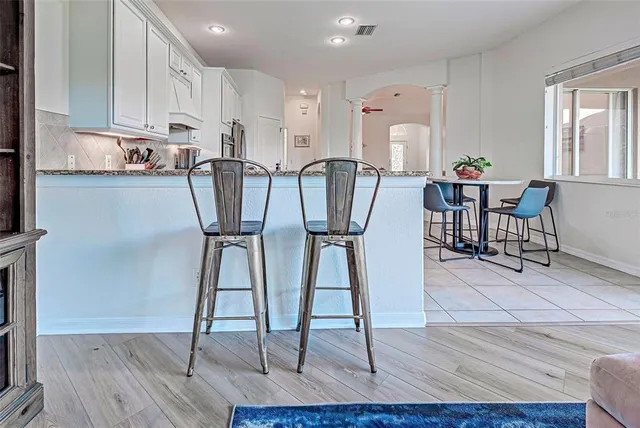 a view of a room with wooden floor closet and windows