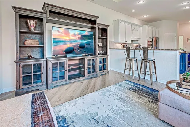 a bedroom with a bed and a dresser next to a window