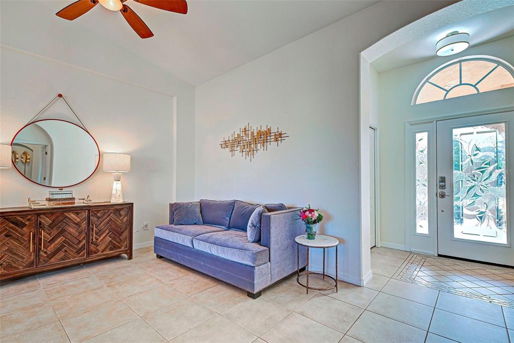 12086 Granite Woods Loop Venice, FL 34292 - Photo 3 of 85 a living room with furniture a rug and a mirror