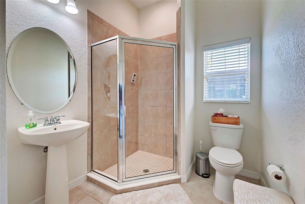 12086 Granite Woods Loop Venice, FL 34292 - Photo 36 of 85 a bathroom with a toilet a sink and a mirror