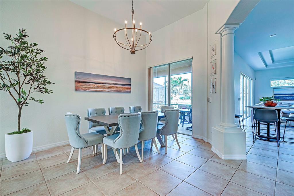 12086 Granite Woods Loop Venice, FL 34292 - Photo 4 of 85 a view of a dining room with furniture and chandelier