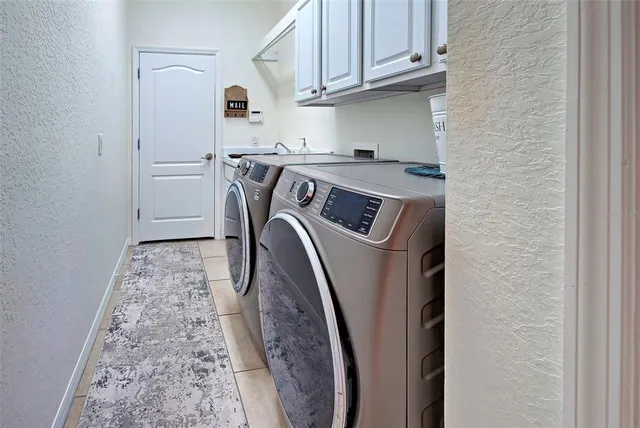 a living room with lots of furniture and kitchen view