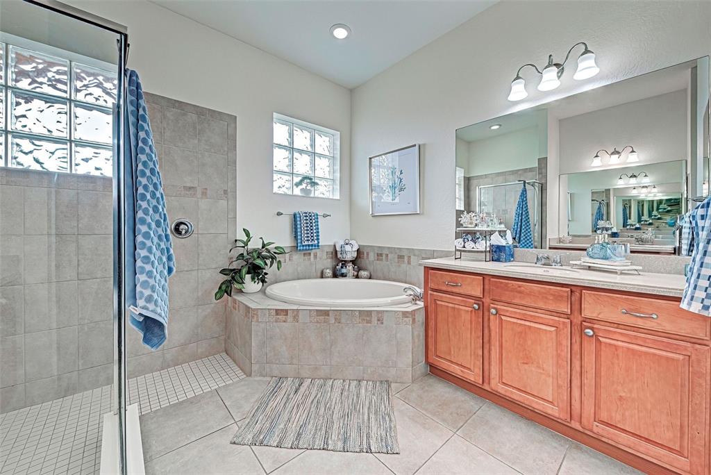 12086 Granite Woods Loop Venice, FL 34292 - Photo 56 of 85 a spacious bathroom with a tub sink and mirror