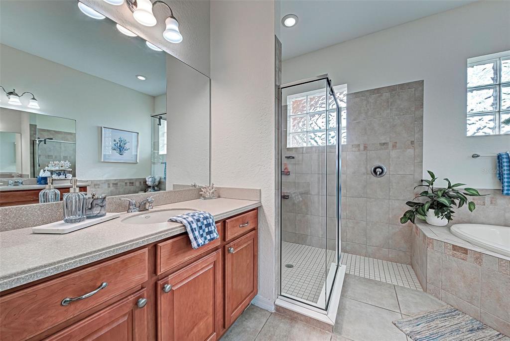 12086 Granite Woods Loop Venice, FL 34292 - Photo 57 of 85 a bathroom with a shower sink vanity granite and mirror