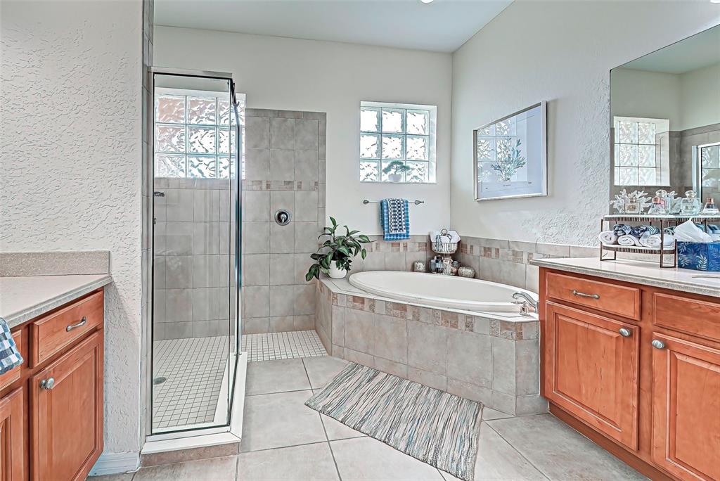 12086 Granite Woods Loop Venice, FL 34292 - Photo 8 of 85 a spacious bathroom with a tub shower and sink