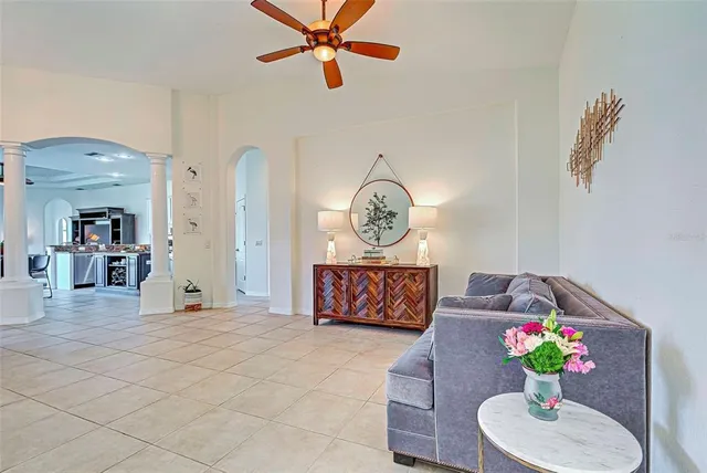 a living room with furniture and a potted plant