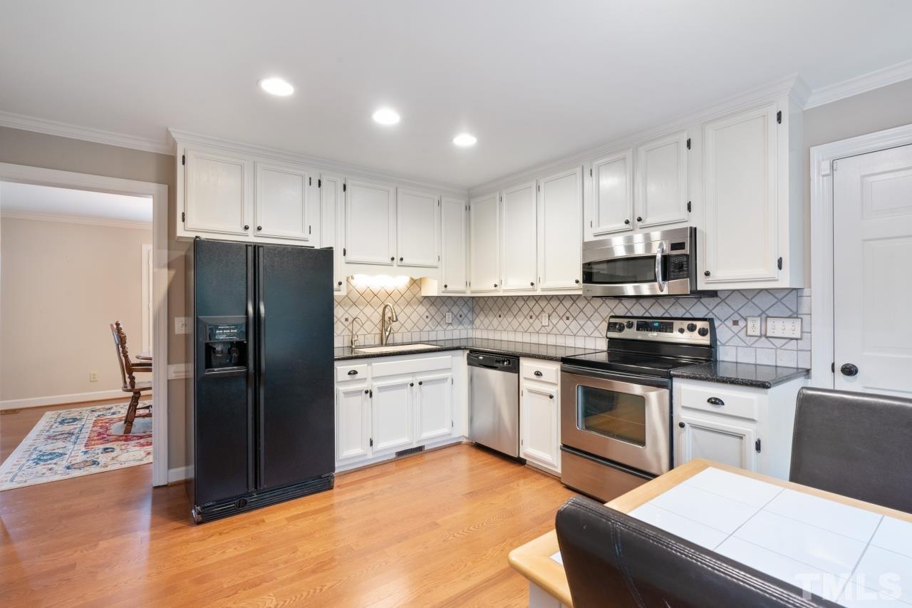 1604 Habbot Drive Raleigh, NC 27603 - Photo 11 of 35 a kitchen with cabinets stainless steel appliances and a counter space