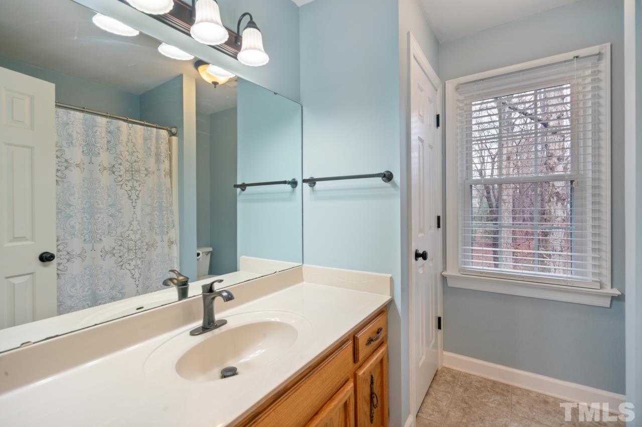 1604 Habbot Drive Raleigh, NC 27603 - Photo 25 of 35 a bathroom with a sink and a mirror