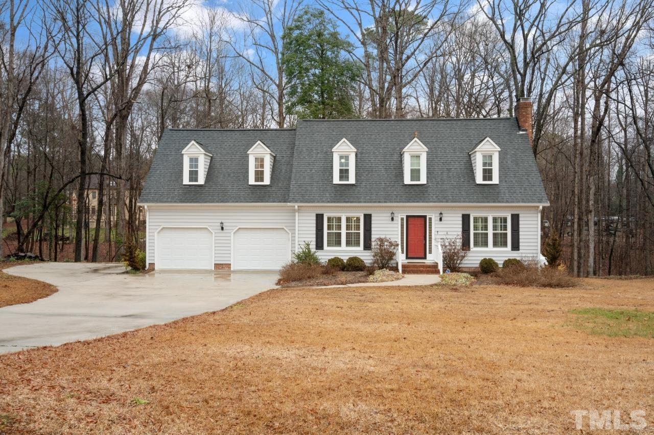 1604 Habbot Drive Raleigh, NC 27603 - Photo 3 of 35 a front view of a house with a yard covered with trees
