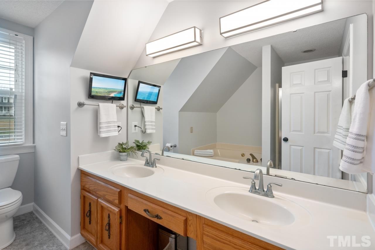 1604 Habbot Drive Raleigh, NC 27603 - Photo 31 of 35 a bathroom with a sink and a mirror