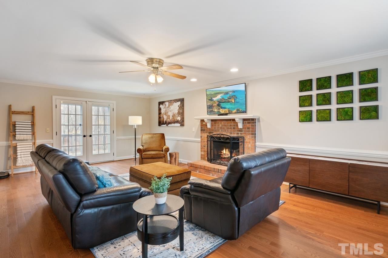 1604 Habbot Drive Raleigh, NC 27603 - Photo 4 of 35 a living room with furniture a fireplace and a large window