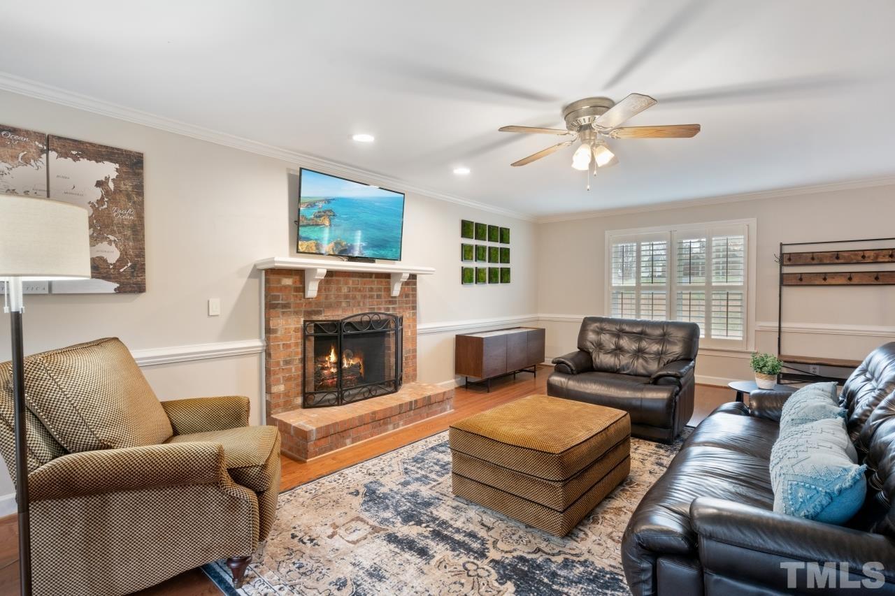 1604 Habbot Drive Raleigh, NC 27603 - Photo 6 of 35 a living room with furniture a fireplace and a window