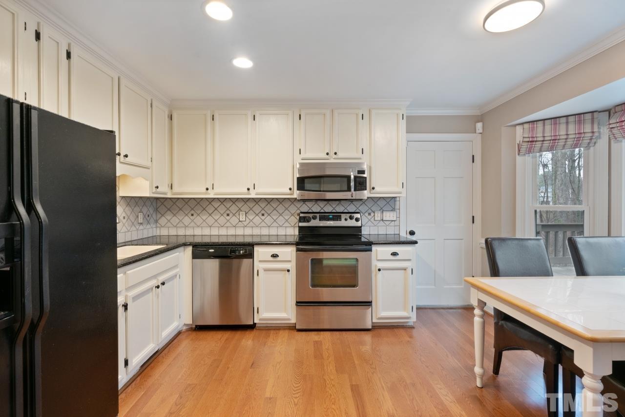 1604 Habbot Drive Raleigh, NC 27603 - Photo 10 of 35 a kitchen with stainless steel appliances granite countertop a refrigerator stove top oven and sink