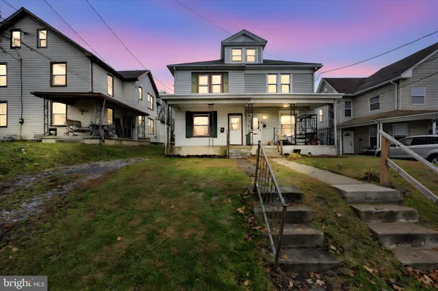 a front view of a residential apartment building with a yard