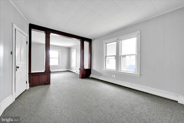 an empty room with windows and closet