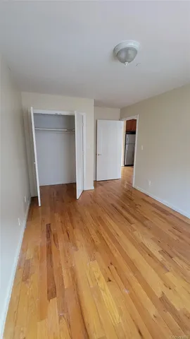 a bedroom with a bed and a night stand