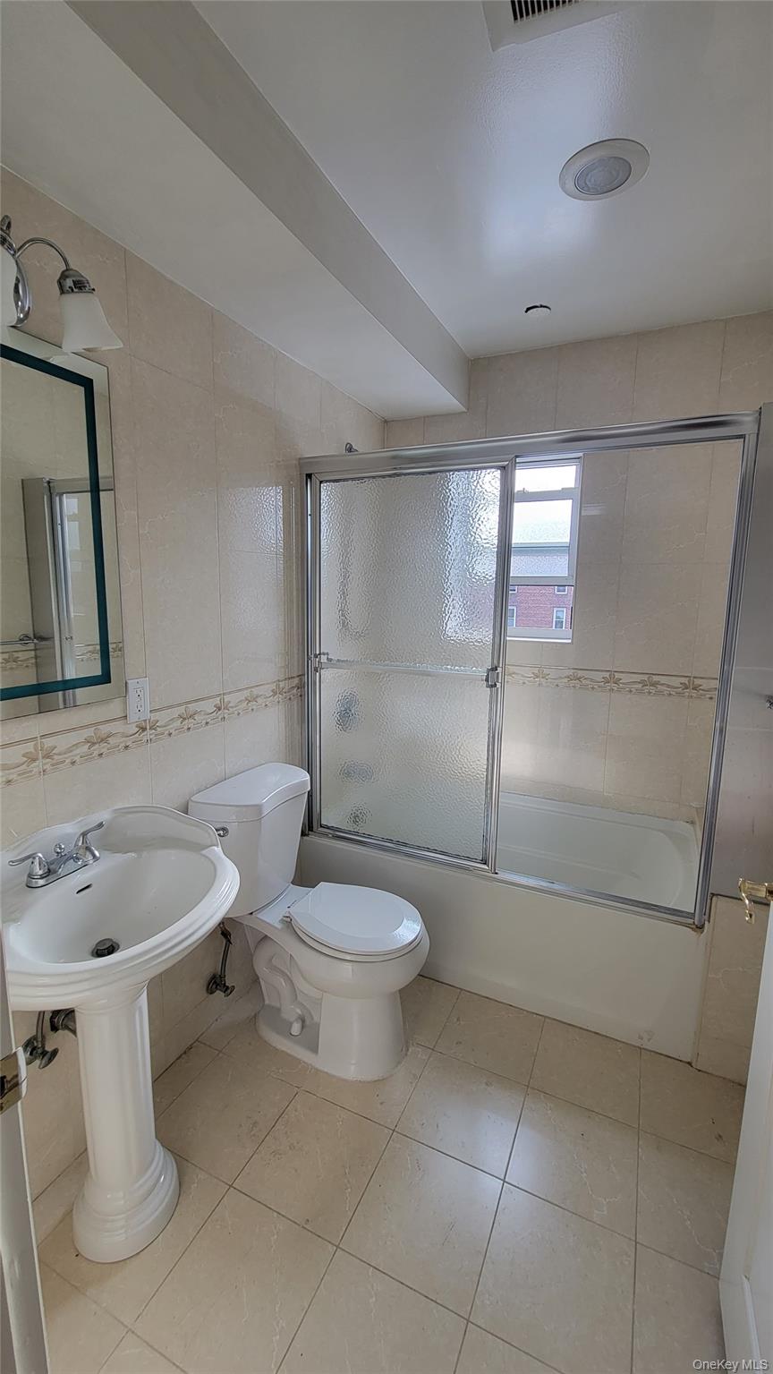 108-27 63rd Avenue, Unit 3B Queens, NY 11375 - Photo 15 of 17 a white toilet sitting next to a bathroom sink