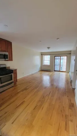 a view of a room window and wooden floor