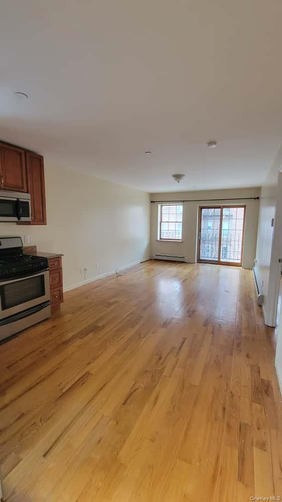 108-27 63rd Avenue, Unit 3B Queens, NY 11375 - Photo 4 of 17 a view of a room window and wooden floor