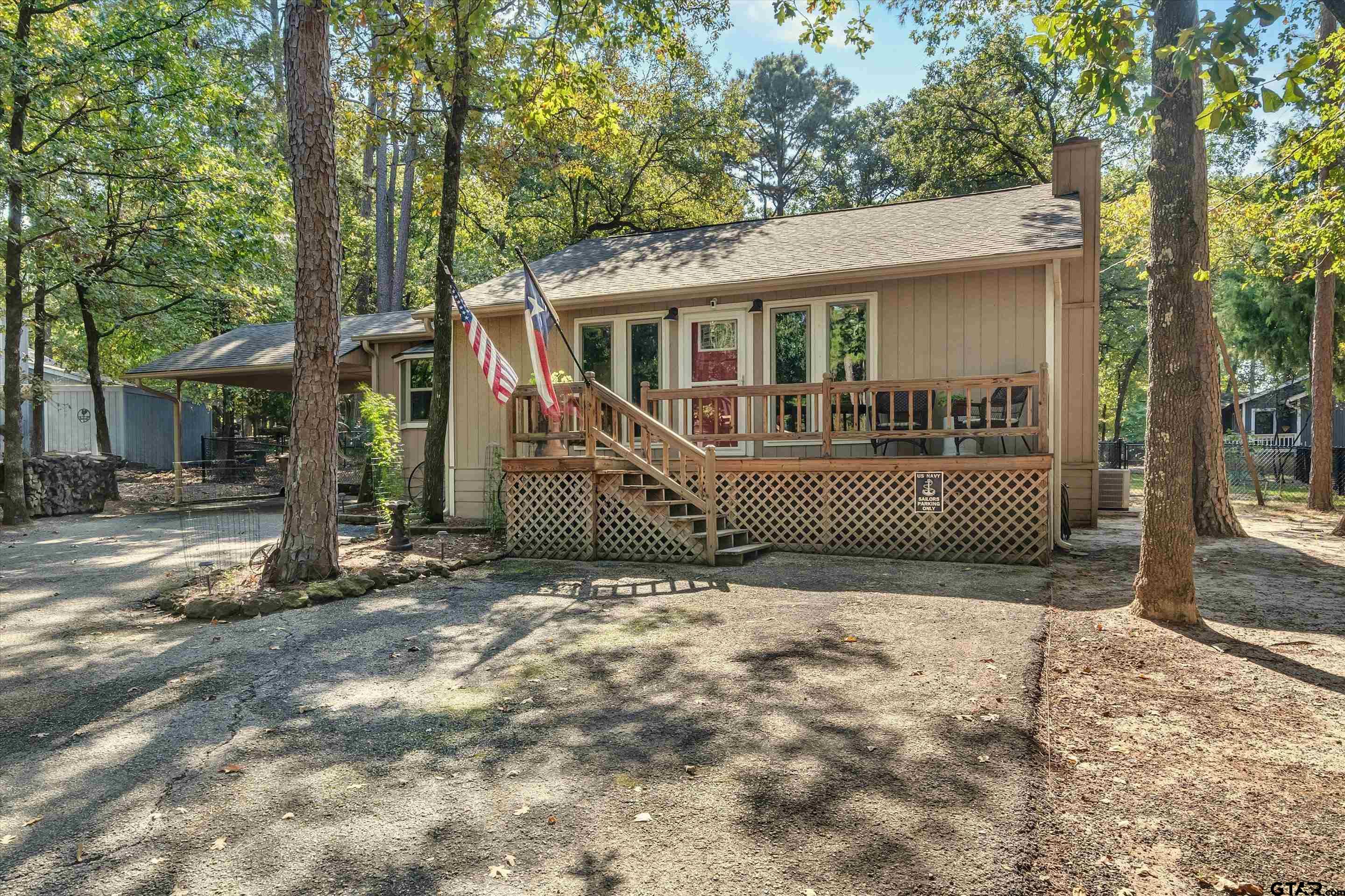 210 Magnolia Lane Holly Lake Ranch, TX 75765 - Photo 3 of 42 a view of a house with a tree in front of it