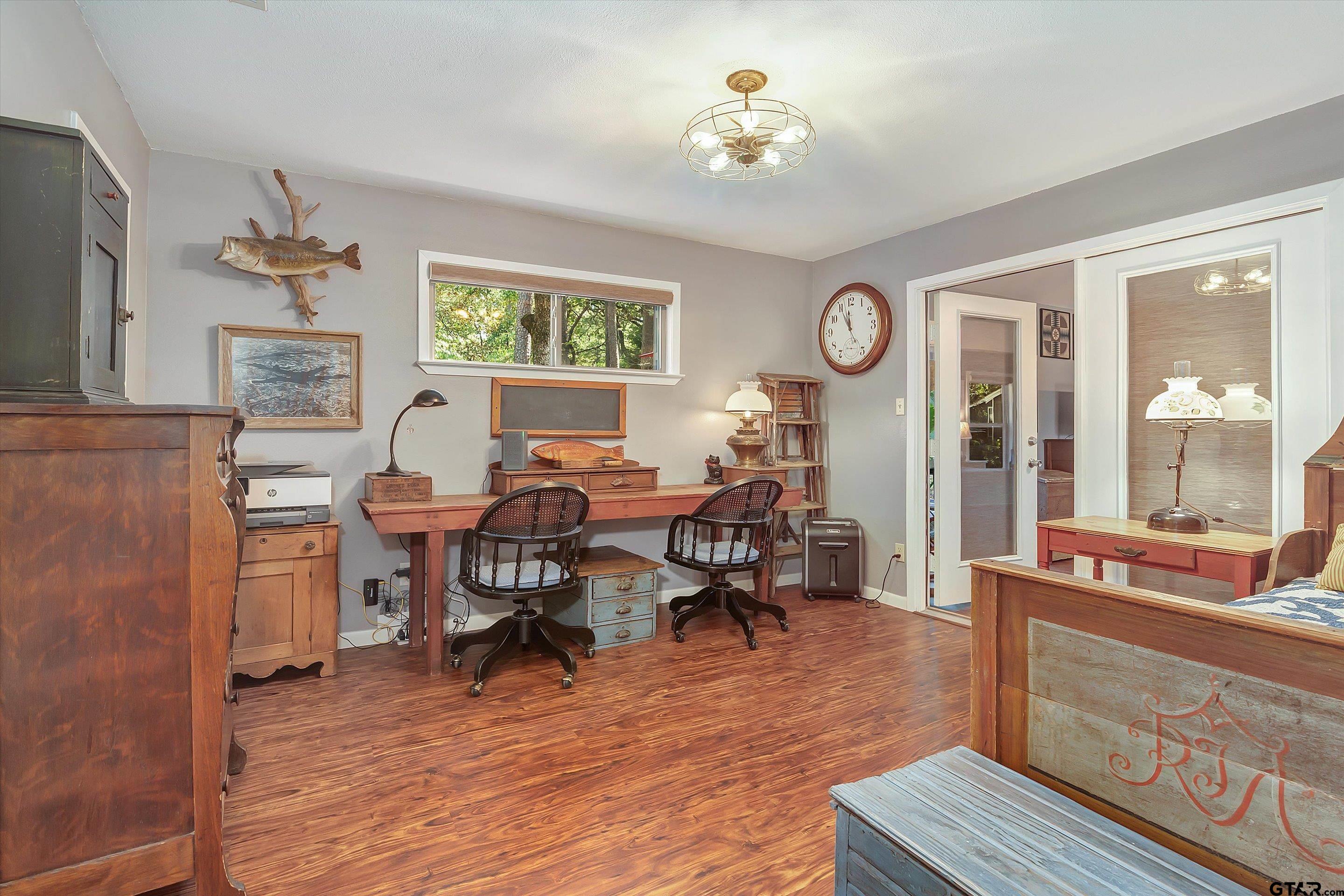 210 Magnolia Lane Holly Lake Ranch, TX 75765 - Photo 33 of 42 a view of a dining room with furniture a chandelier and wooden floor