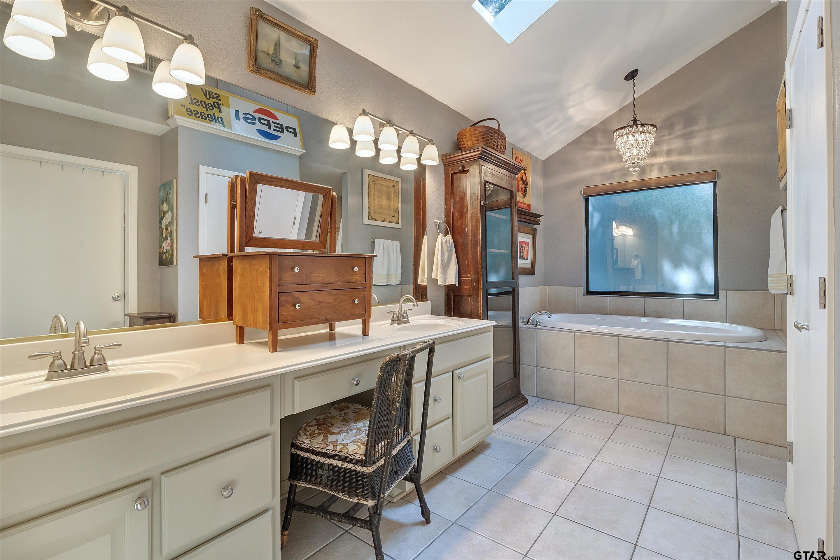 210 Magnolia Lane Holly Lake Ranch, TX 75765 - Photo 38 of 42 a spacious bathroom with a sink a mirror and a bathtub