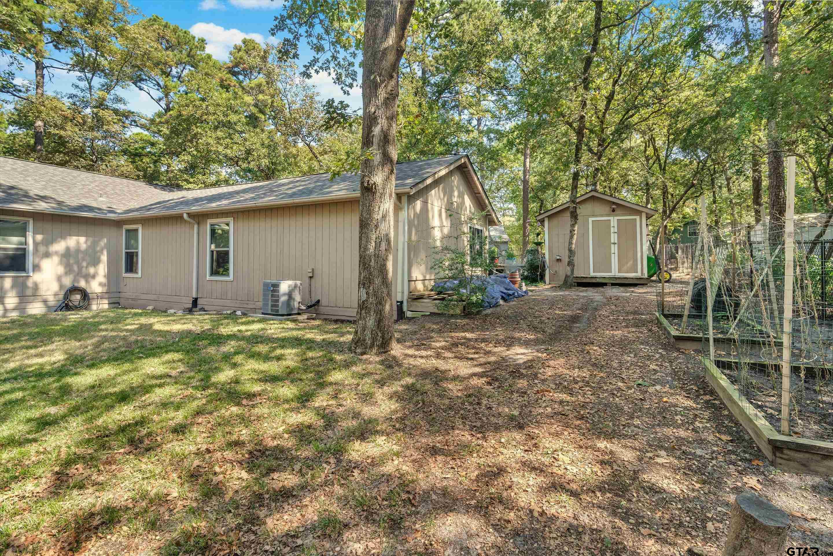 210 Magnolia Lane Holly Lake Ranch, TX 75765 - Photo 5 of 42 a backyard of a house with table and chairs
