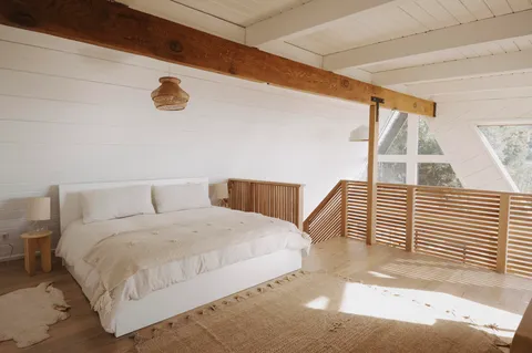 a bedroom with a bed and a large window