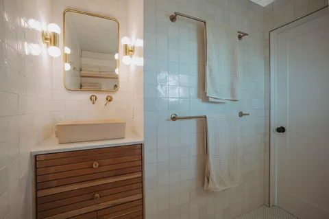 a bathroom with a shower and mirror