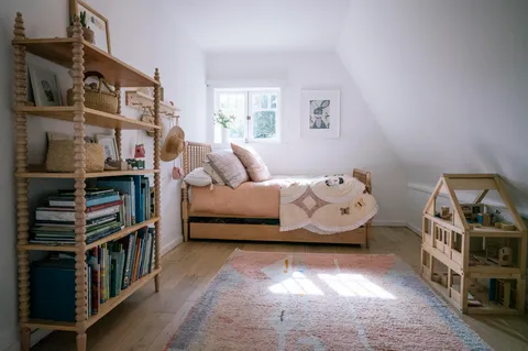 a living room with lots of furniture and a book shelf