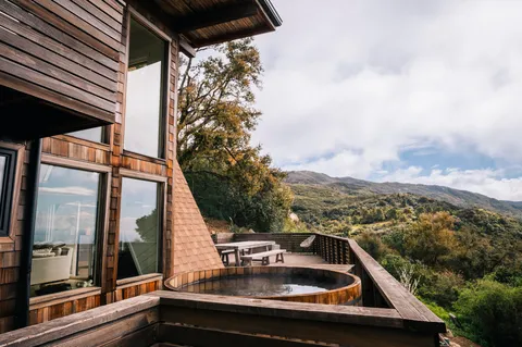 a roof deck with couches and wooden floor