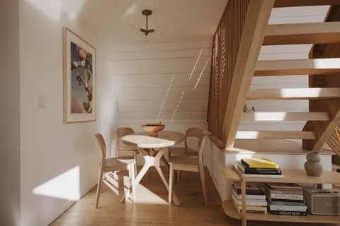 a view of a dining room with furniture and wooden floor