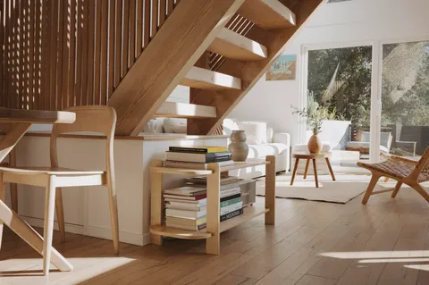 a dining room with furniture entryway and wooden floor