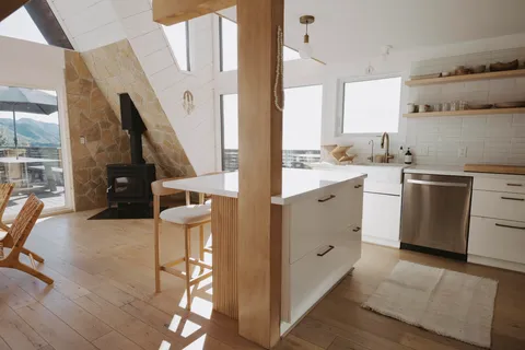 a kitchen with cabinets and wooden floor