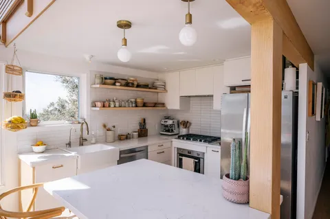 a kitchen with a sink stainless steel appliances and cabinets