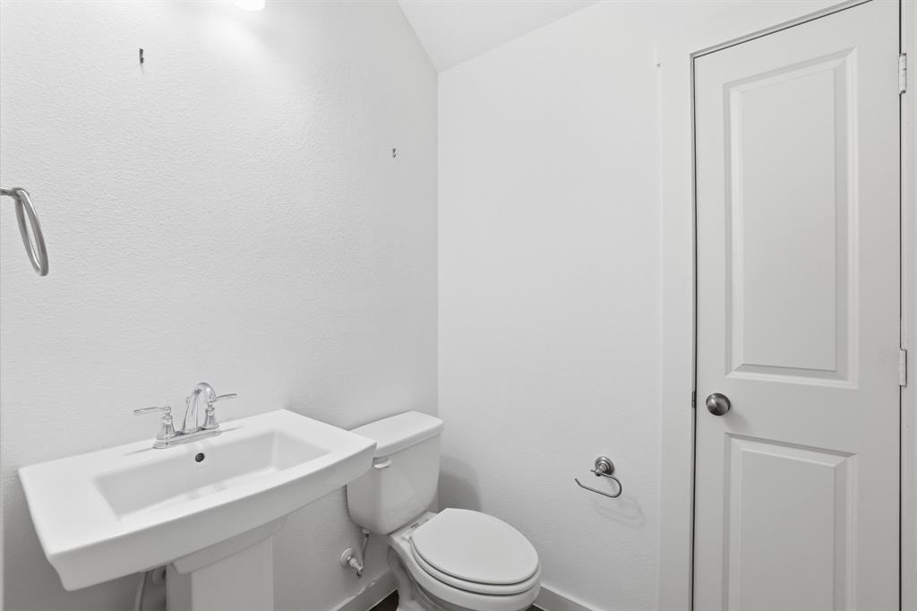 5832 Ridgeline Drive McKinney, TX 75070 - Photo 13 of 26 a bathroom with a toilet a sink and mirror