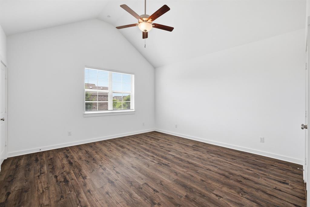 5832 Ridgeline Drive McKinney, TX 75070 - Photo 20 of 26 an empty room with wooden floor ceiling fan and windows