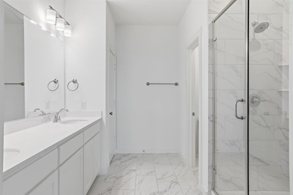 5832 Ridgeline Drive McKinney, TX 75070 - Photo 21 of 26 a bathroom with a shower and a sink