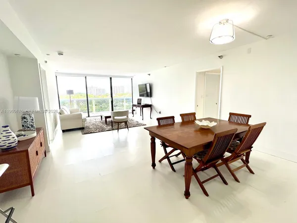 a view of a dining room with furniture and a chandelier