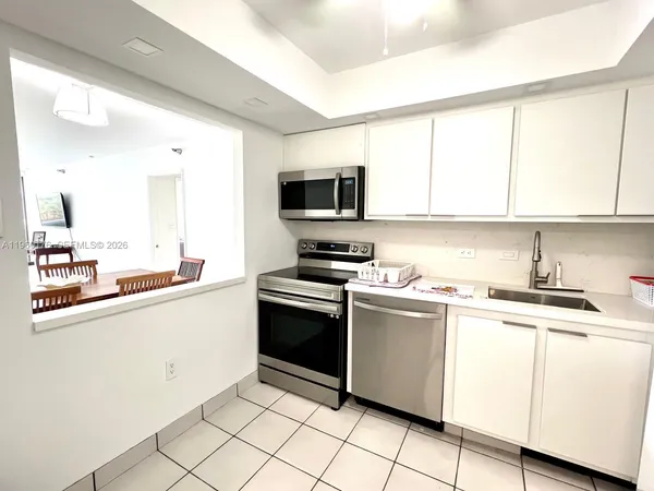 a kitchen with granite countertop a sink and steel appliances