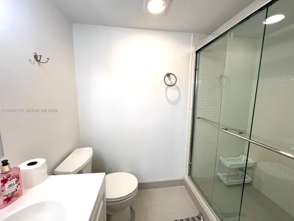 a white toilet sitting next to a bathroom sink
