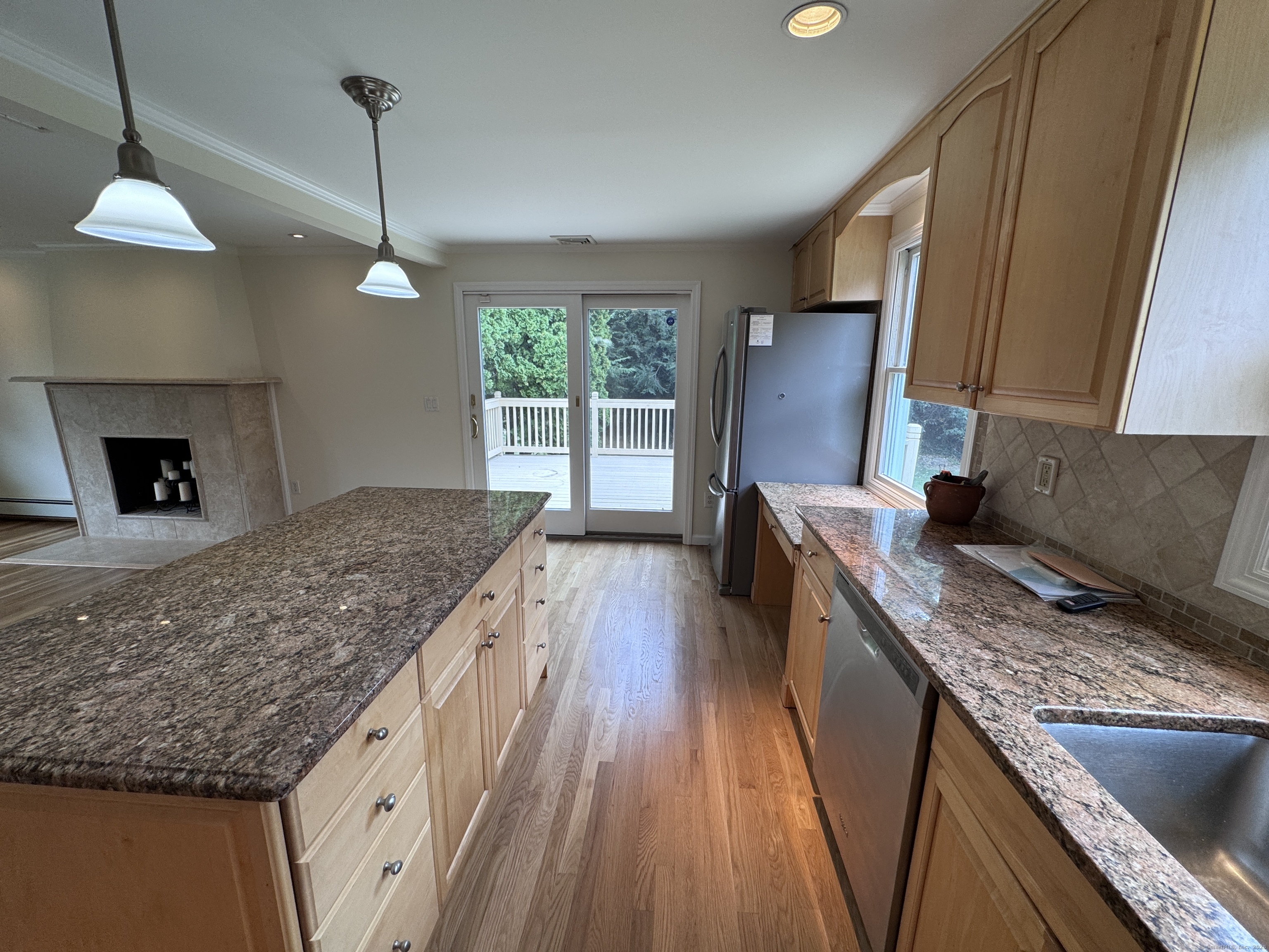 18 Hales Road Westport, CT 06880 - Photo 5 of 26 a kitchen with kitchen island granite countertop a sink a counter top space appliances and cabinets