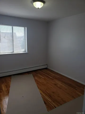 a view of a room with wooden floor and window
