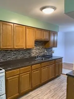 a kitchen with stainless steel appliances granite countertop cabinets and wooden floor