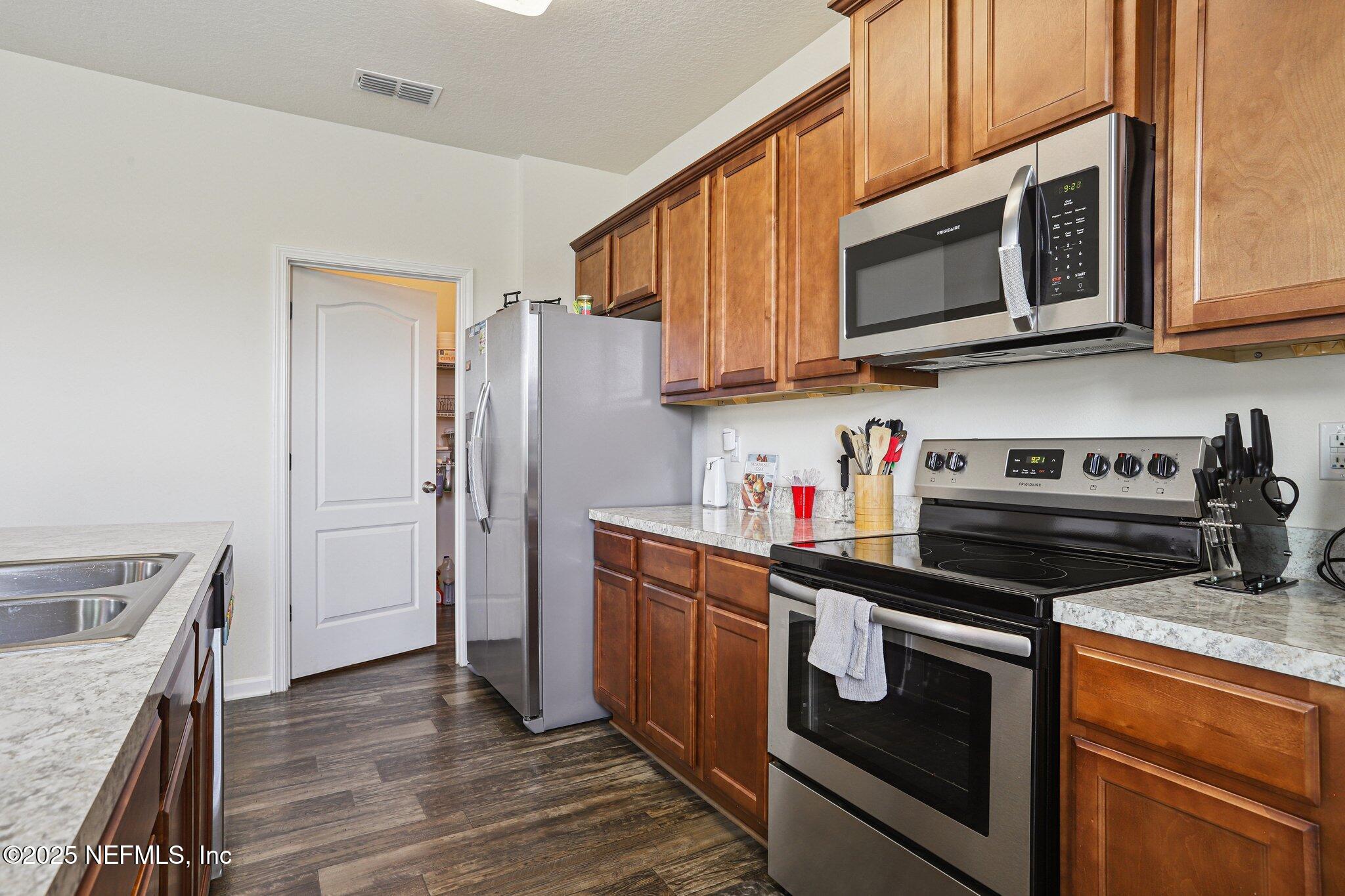 6829 Hanford Street Jacksonville, FL 32219 - Photo 12 of 24 a kitchen with stainless steel appliances granite countertop a stove microwave and refrigerator