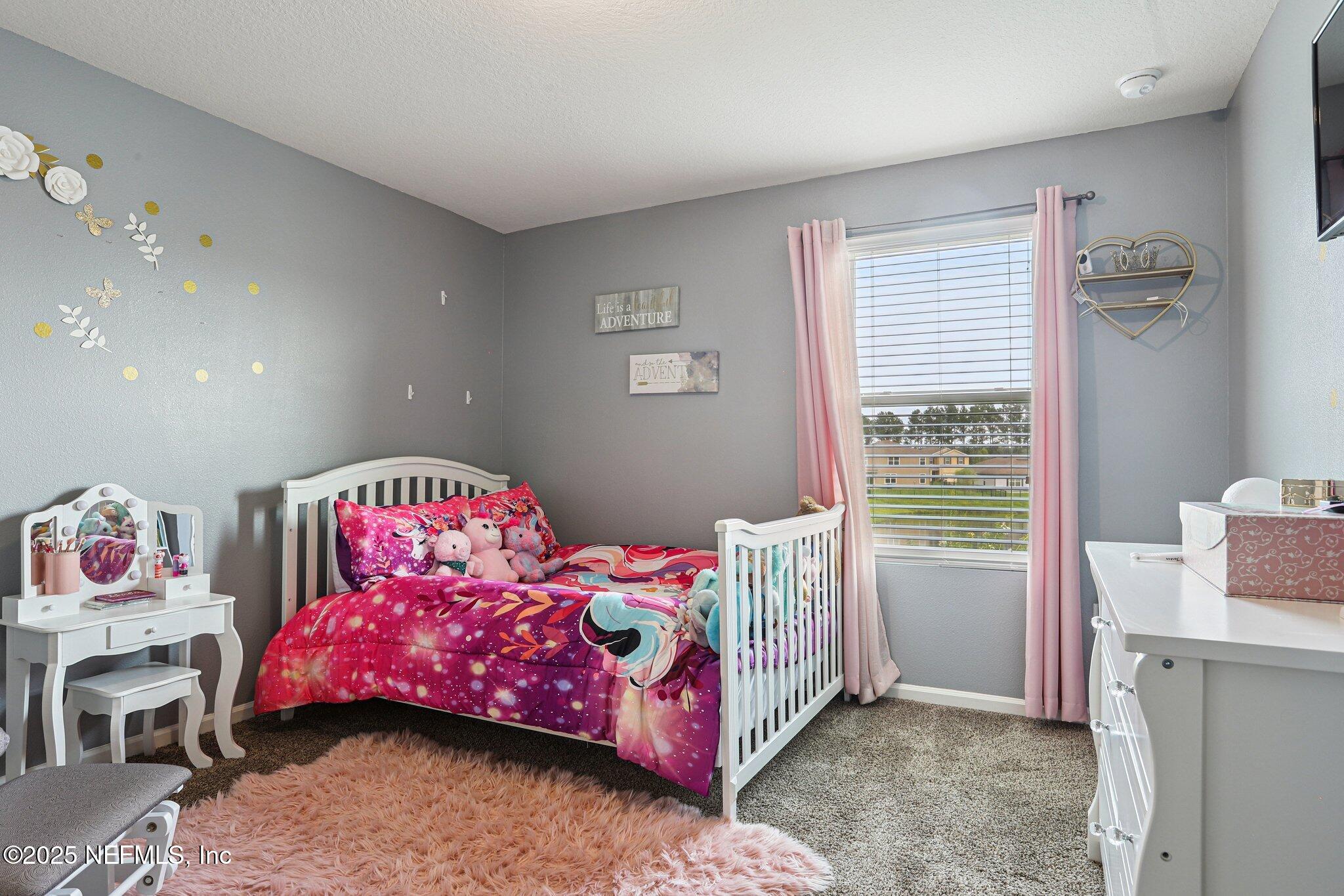 6829 Hanford Street Jacksonville, FL 32219 - Photo 18 of 24 a bedroom with a bed and a window