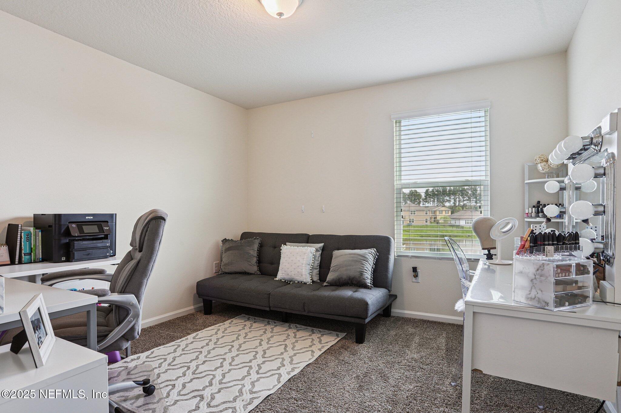 6829 Hanford Street Jacksonville, FL 32219 - Photo 19 of 24 a living room with furniture and a window