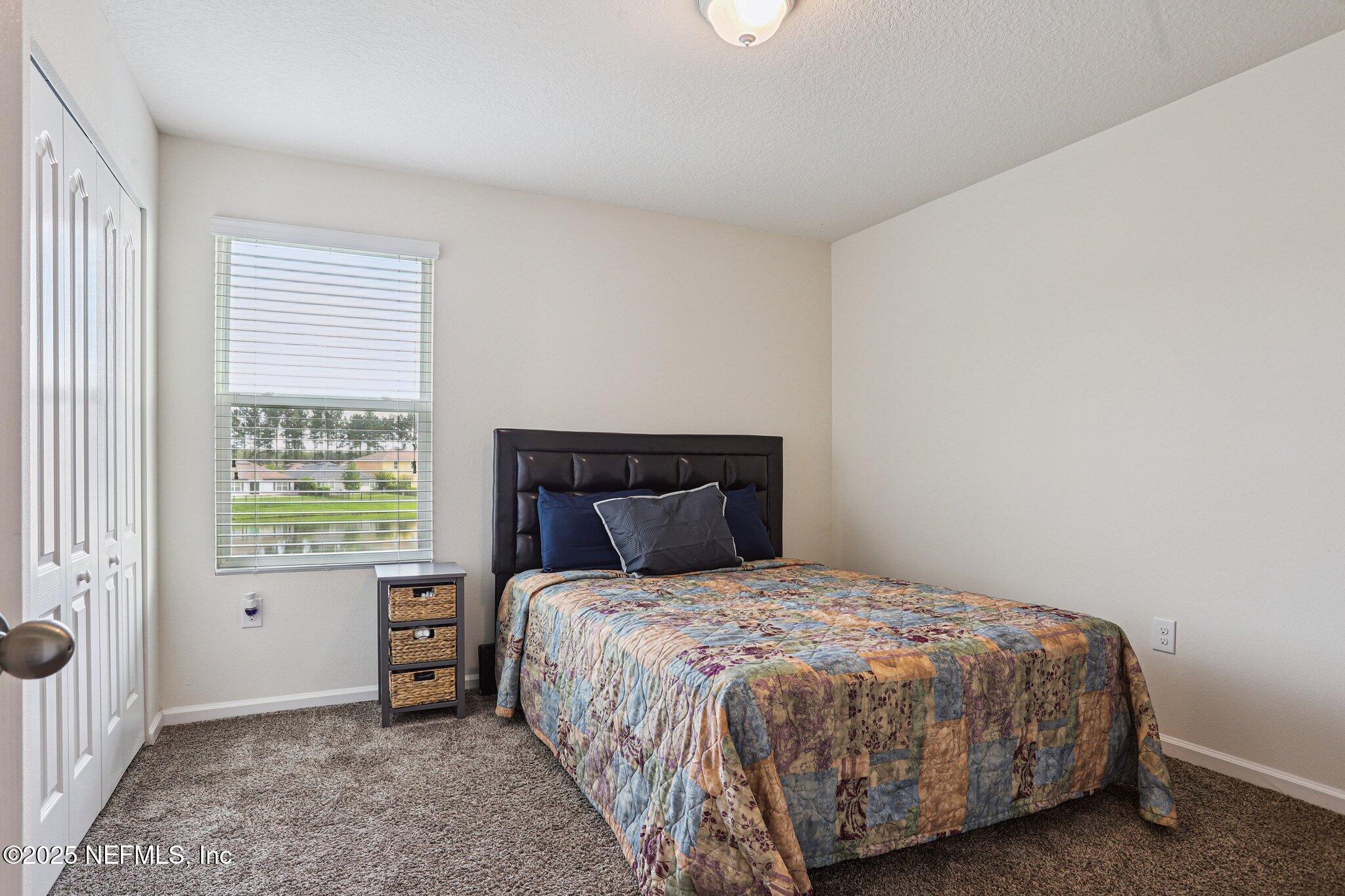 6829 Hanford Street Jacksonville, FL 32219 - Photo 20 of 24 a bedroom with a bed and a window