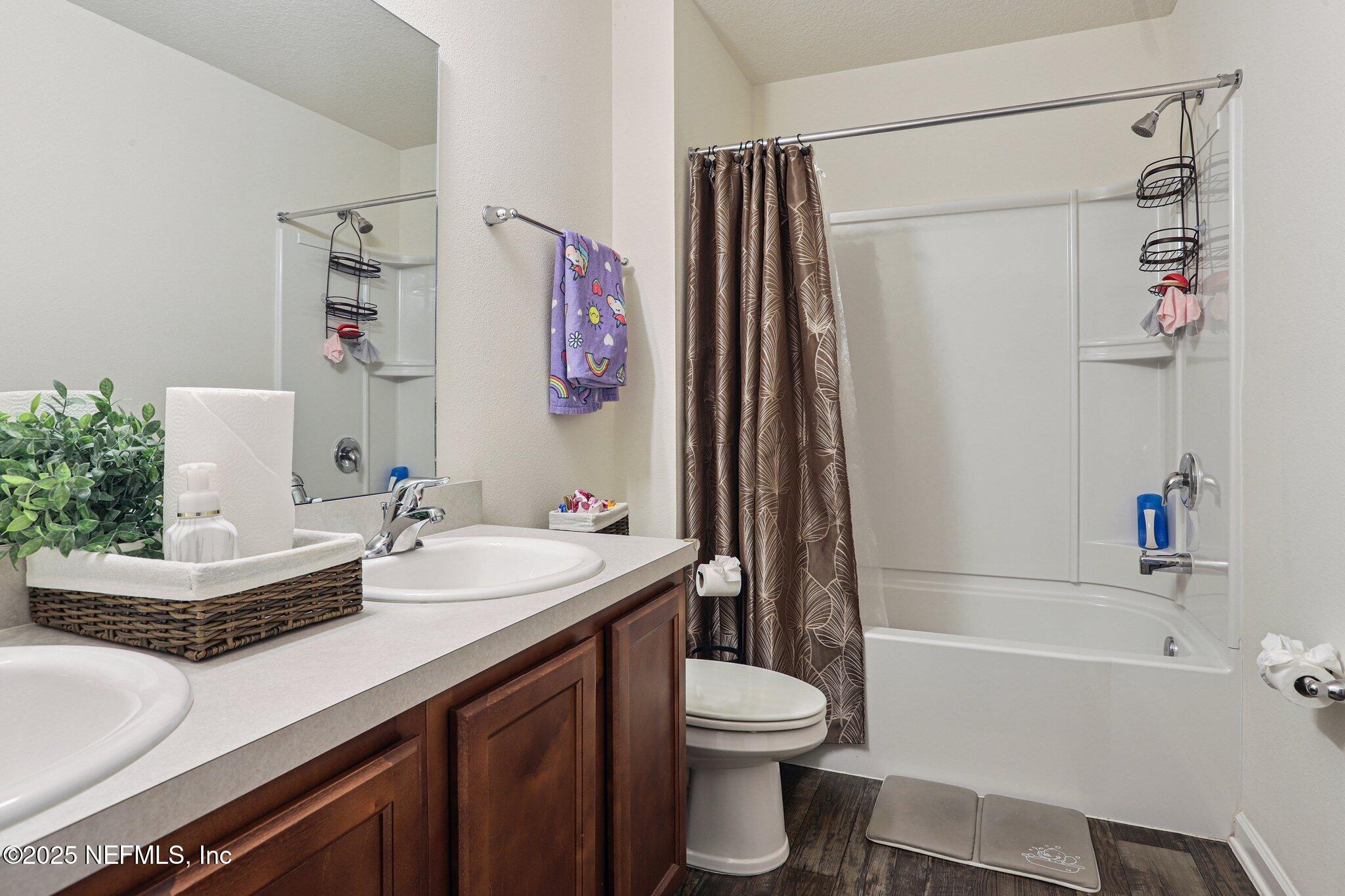 6829 Hanford Street Jacksonville, FL 32219 - Photo 21 of 24 a bathroom with a granite countertop sink a toilet and a bathtub