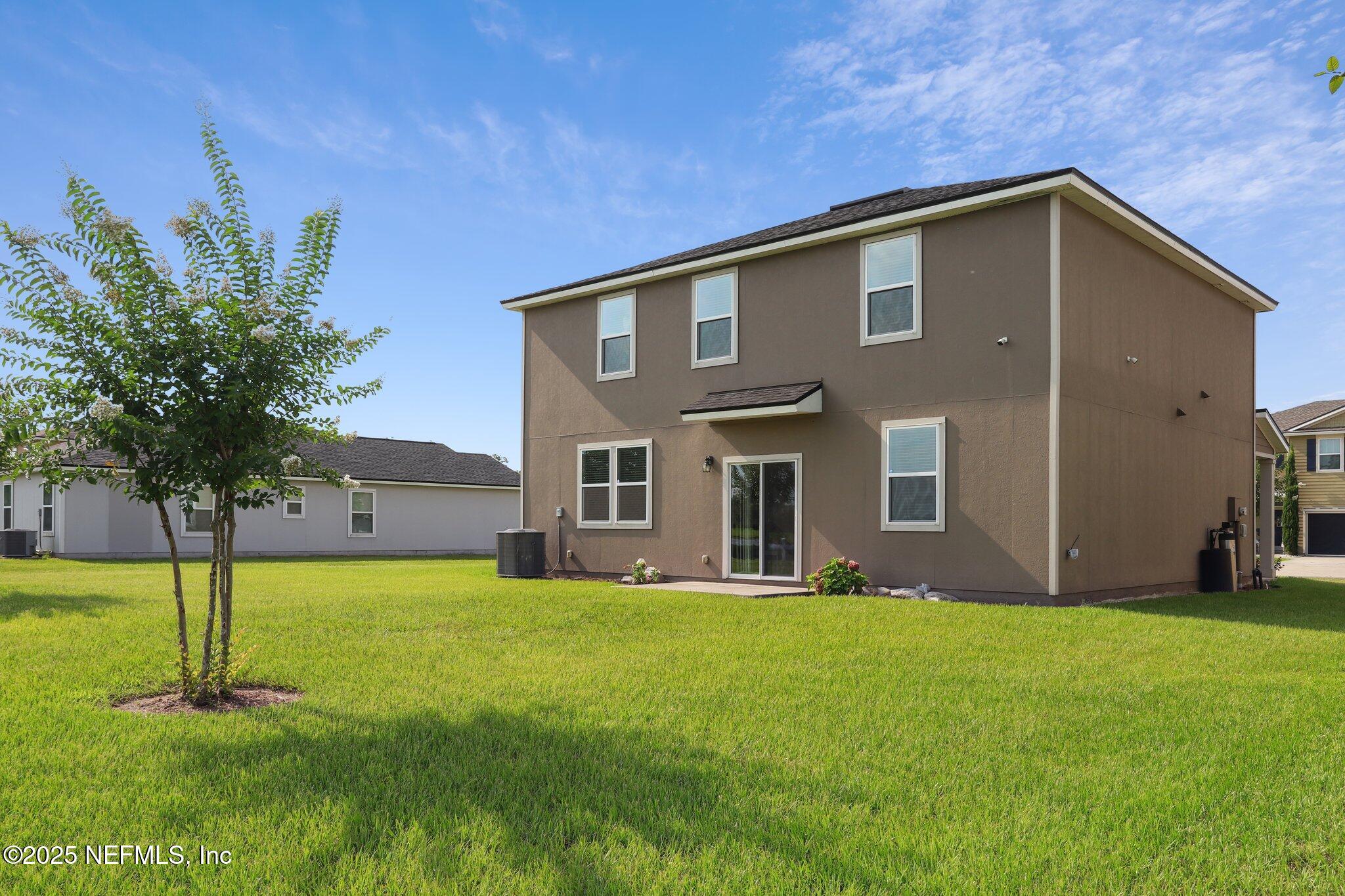 6829 Hanford Street Jacksonville, FL 32219 - Photo 23 of 24 a front view of house with yard and tree in the background